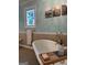 Elegant bathroom with a soaking tub, vintage fixtures and stained-glass window at 140 Julie Rd, Tyrone, GA 30290