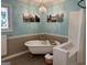 Elegant bathroom featuring a clawfoot tub, stained glass window, and walk-in shower at 140 Julie Rd, Tyrone, GA 30290