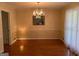Traditional dining room with hardwood floors, wainscoting, and chandelier adds a touch of elegance at 140 Julie Rd, Tyrone, GA 30290