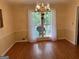 Dining room with hardwood floors, wainscotting, and chandelier, great for entertaining with forest views at 140 Julie Rd, Tyrone, GA 30290