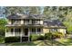 Charming two-story home featuring a welcoming front porch and lush, well-maintained landscaping at 140 Julie Rd, Tyrone, GA 30290