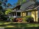 Charming yellow home with beautiful landscaping and a welcoming front porch at 140 Julie Rd, Tyrone, GA 30290