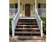 Inviting front steps leading to a charming wooden door with a decorative wreath at 140 Julie Rd, Tyrone, GA 30290