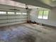 A spacious garage interior with ample room for parking and storage, featuring an automatic door and natural light at 140 Julie Rd, Tyrone, GA 30290