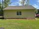Exterior shot of the detached garage, siding view, with a well-maintained yard at 140 Julie Rd, Tyrone, GA 30290