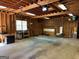 View of the detached garage interior with wood support beams and concrete floor at 140 Julie Rd, Tyrone, GA 30290