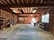 Inside the detached garage with exposed beams, built in shelving, and concrete floors at 140 Julie Rd, Tyrone, GA 30290