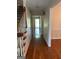 Hallway with hardwood floors leading to the front door and staircase at 140 Julie Rd, Tyrone, GA 30290