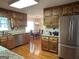 Fully equipped eat-in kitchen with stainless steel appliances and hardwood flooring, next to breakfast nook at 140 Julie Rd, Tyrone, GA 30290