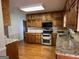 Fully equipped eat-in kitchen with stainless steel appliances and granite countertops with room to cook at 140 Julie Rd, Tyrone, GA 30290
