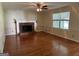 Spacious living room with hardwood flooring, brick fireplace, and natural light from large windows at 140 Julie Rd, Tyrone, GA 30290