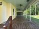 Spacious covered porch with wooden flooring and ceiling fans offering a relaxing outdoor space at 140 Julie Rd, Tyrone, GA 30290