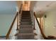 A carpeted staircase leads to the upper level, featuring white spindles and wooden handrails at 140 Julie Rd, Tyrone, GA 30290