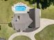 A bird's eye view of a large backyard pool with lounge chairs on the concrete deck at 207 Jamestown Ave, Jonesboro, GA 30236