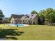 Expansive backyard featuring a sparkling swimming pool, patio area, and lush lawn for entertaining at 207 Jamestown Ave, Jonesboro, GA 30236