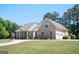 Elegant home featuring an attached two-car garage and a charming front porch with a long, winding driveway at 207 Jamestown Ave, Jonesboro, GA 30236
