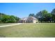 Beautiful home with an attached garage, manicured lawn and a long driveway at 207 Jamestown Ave, Jonesboro, GA 30236