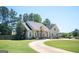 Charming home with a curved driveway, columns, and a well-manicured front yard, blending elegance and curb appeal at 207 Jamestown Ave, Jonesboro, GA 30236
