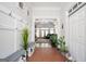 Inviting foyer with coat hooks, storage, and open view to the home's living area with fireplace and vaulted ceilings at 207 Jamestown Ave, Jonesboro, GA 30236