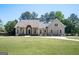 Charming single-Gathering home with a well-manicured lawn, inviting entrance and elegant architectural details at 207 Jamestown Ave, Jonesboro, GA 30236