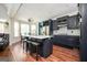 Open-concept kitchen with a large island and seating, stainless steel appliances and views to the dining room at 207 Jamestown Ave, Jonesboro, GA 30236