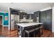 Kitchen with island, stainless steel appliances, and dark cabinets with ample storage space at 207 Jamestown Ave, Jonesboro, GA 30236