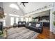 Open-concept living room flows into the kitchen, featuring hardwood floors, fireplace, and vaulted ceilings at 207 Jamestown Ave, Jonesboro, GA 30236