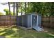 Metal storage shed in a fenced yard with a ramp for easy access, providing secure outdoor storage at 207 Jamestown Ave, Jonesboro, GA 30236