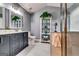 Stylish bathroom featuring a vanity, sleek mirror, glass shelves, and standup shower at 7750 Carnegie Dr, Fairburn, GA 30213