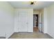 A bright bedroom featuring neutral walls, plush carpeting, and a closet at 7750 Carnegie Dr, Fairburn, GA 30213