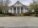 Exterior shot of clubhouse featuring stately columns, manicured landscaping, and a welcoming entrance at 7750 Carnegie Dr, Fairburn, GA 30213