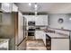 Modern kitchen with stainless steel appliances, sleek countertops, and stylish lighting at 7750 Carnegie Dr, Fairburn, GA 30213