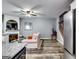 Bright open-concept living area with fireplace, wood floors, and view of stairs at 7750 Carnegie Dr, Fairburn, GA 30213