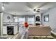 Open concept living room featuring modern finishes and fireplace with bright natural light at 7750 Carnegie Dr, Fairburn, GA 30213