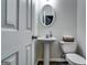 Cozy powder room with pedestal sink, oval mirror and a classic design at 7750 Carnegie Dr, Fairburn, GA 30213