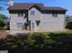 View of the home's rear exterior featuring vinyl siding and a well-maintained yard at 7541 Coddington Ct, Riverdale, GA 30274