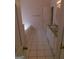 Well-lit bathroom features a tub, vanity with granite countertop, and white-tiled flooring at 7541 Coddington Ct, Riverdale, GA 30274