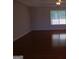 Spacious bedroom with hardwood flooring, neutral paint, and window overlooking backyard at 7541 Coddington Ct, Riverdale, GA 30274