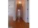 Hardwood hallway that connects different rooms, with doors and lighting at 7541 Coddington Ct, Riverdale, GA 30274