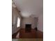 Cozy living room with a brick fireplace, hardwood floors, and natural light at 7541 Coddington Ct, Riverdale, GA 30274