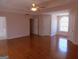 Spacious main bedroom with hardwood floors, large window, and access to the bathroom at 7541 Coddington Ct, Riverdale, GA 30274