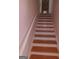 Staircase features wood treads, white risers, and a white painted handrail at 7541 Coddington Ct, Riverdale, GA 30274