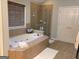 Large bathroom featuring a soaking tub with a glass shower at 514 Augusta Dr, Canton, GA 30115