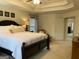 Spacious primary bedroom with a tray ceiling and a ceiling fan at 514 Augusta Dr, Canton, GA 30115