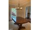 Dining room featuring an oversized wood table, a large window and elegant columns for a welcoming entertaining space at 514 Augusta Dr, Canton, GA 30115