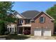 Charming two-story brick home featuring a two-car garage and beautifully landscaped front yard at 514 Augusta Dr, Canton, GA 30115