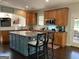 Eat-in kitchen featuring a center island with seating, stainless steel appliances, and wooden cabinets at 514 Augusta Dr, Canton, GA 30115