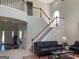 Open concept living room featuring a staircase leading to the second floor and large windows at 514 Augusta Dr, Canton, GA 30115