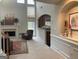 Cozy living room showcasing a fireplace, high ceilings, and an archway looking into the kitchen at 514 Augusta Dr, Canton, GA 30115