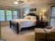 Serene main bedroom with tray ceiling, natural light, and a cozy sitting area offering a peaceful retreat at 514 Augusta Dr, Canton, GA 30115